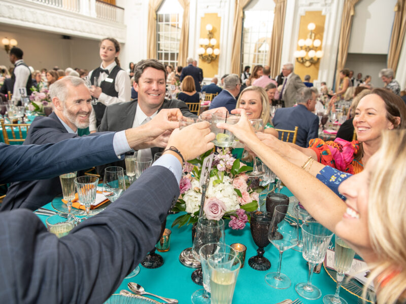 a table of adults cheers