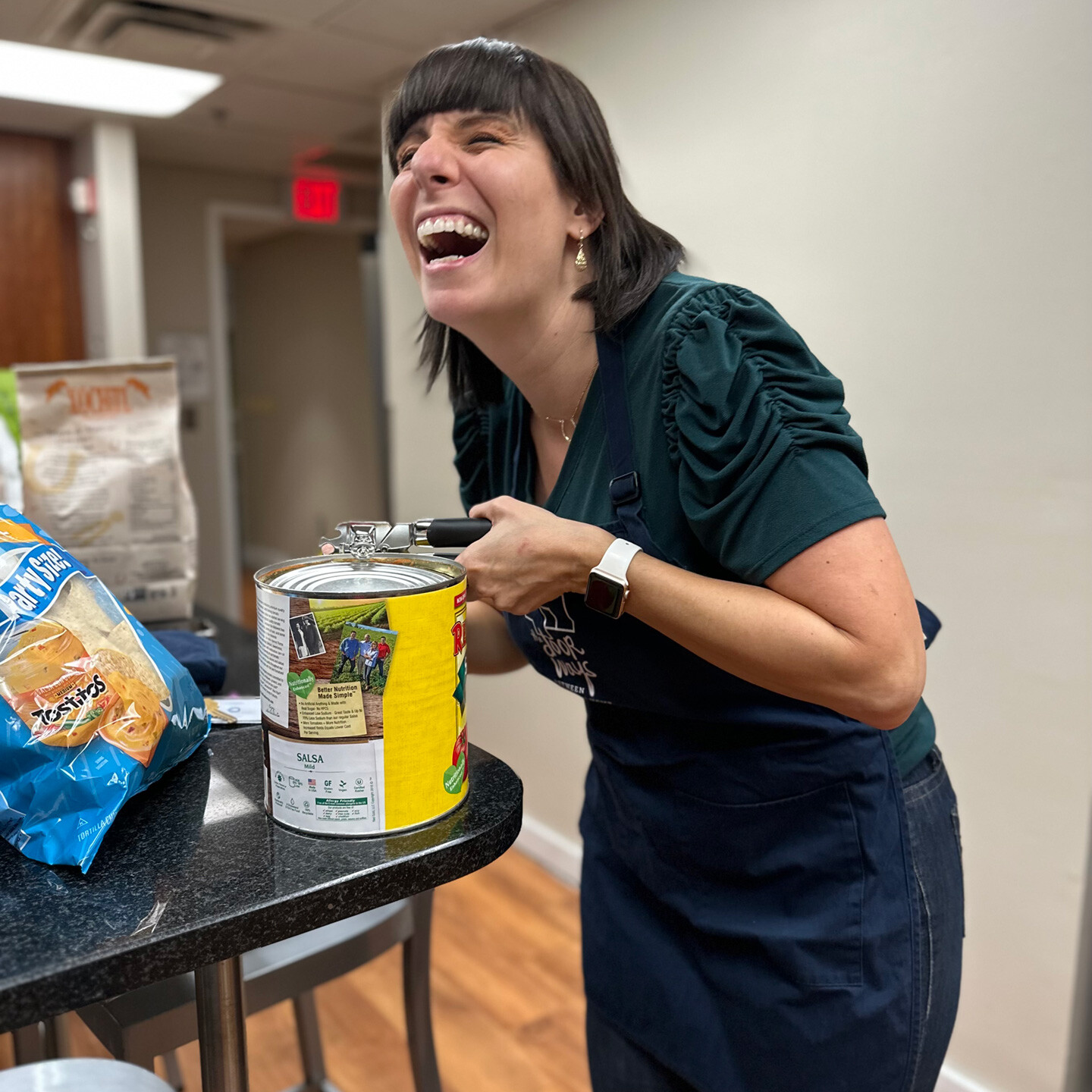 Tobie opening large can of salsa