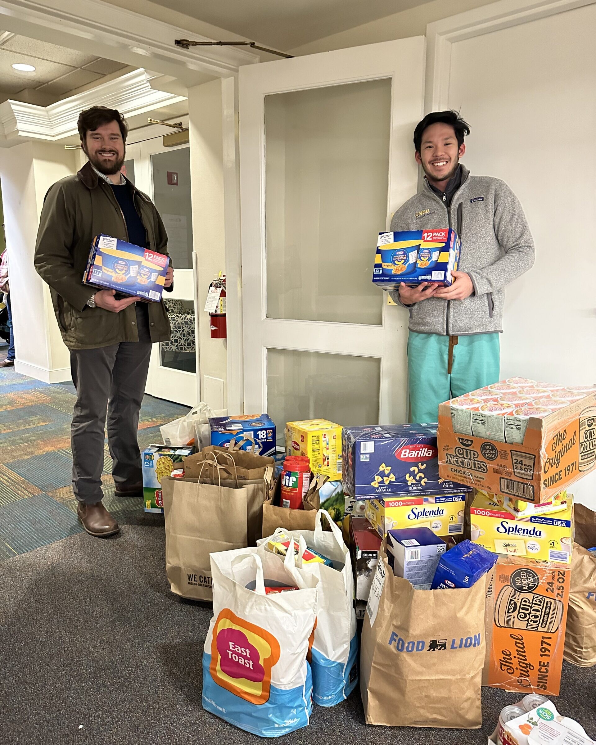 Volunteers bringing bags of food to The Doorways