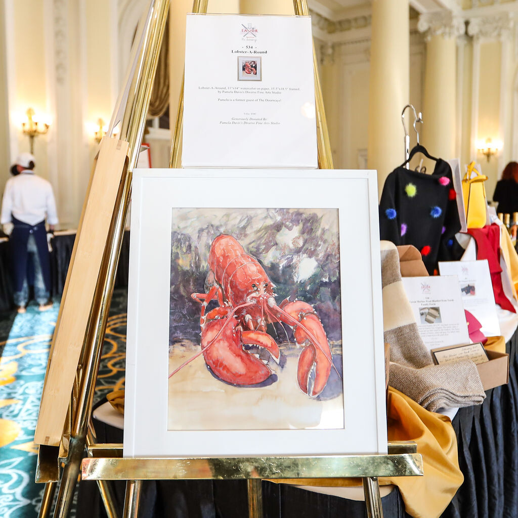 a framed painting of a lobster on display