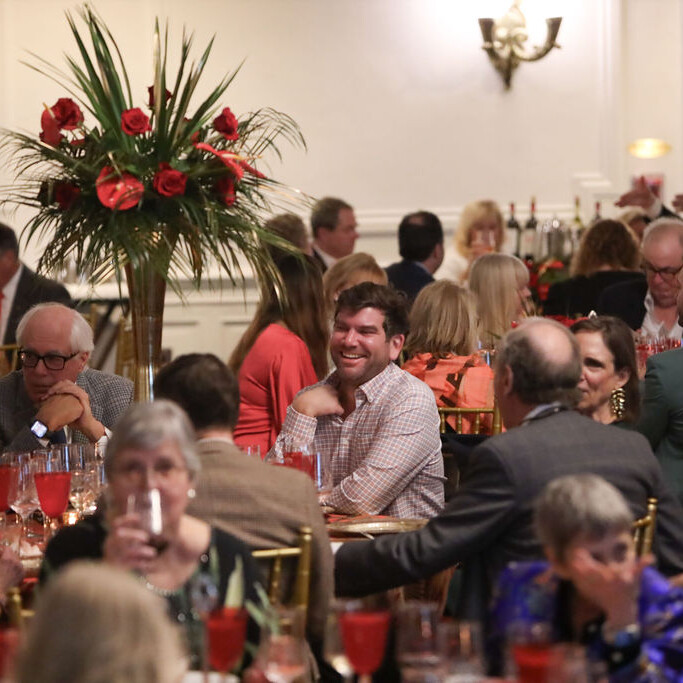 people smile at a seated dinner