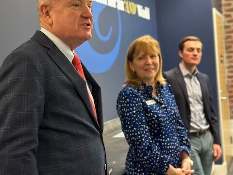 Group shot of three adults presenting