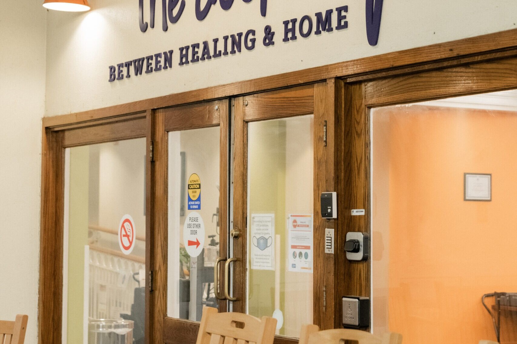 lobby doors with two rocking chairs and The Doorways logo