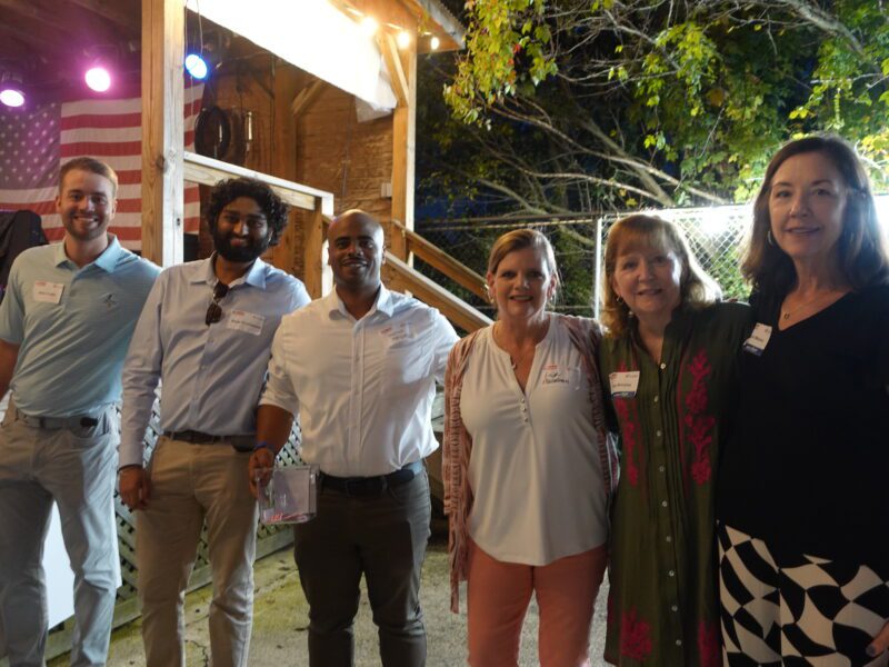 6 smiling adults stand in a line at Main Line Brewery