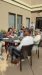 a group of people sit clap at a table