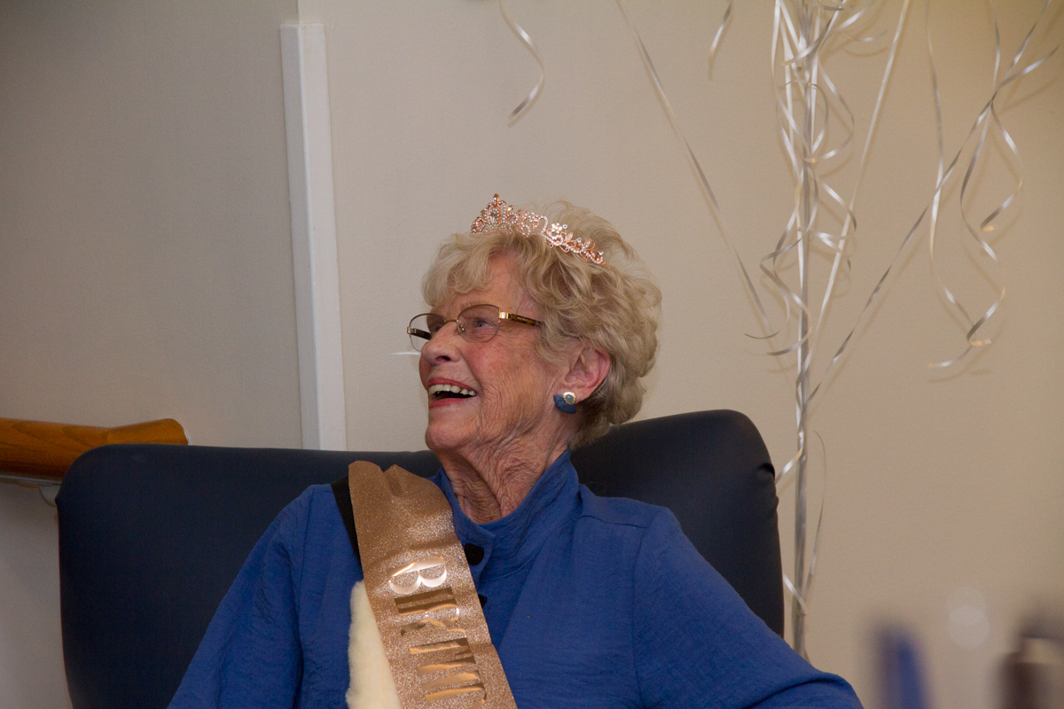 a smiling person serving the community