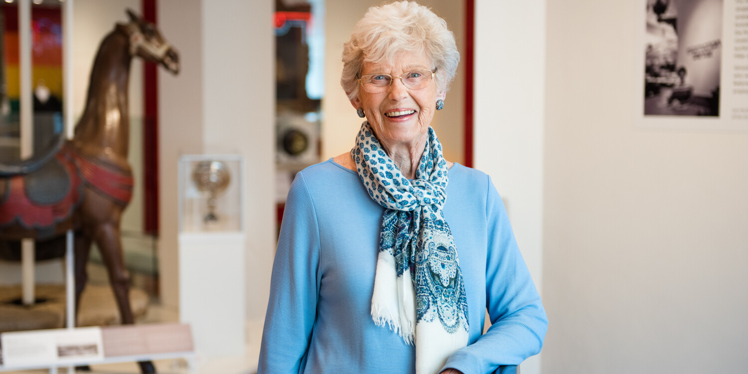 a smiling person serving the community