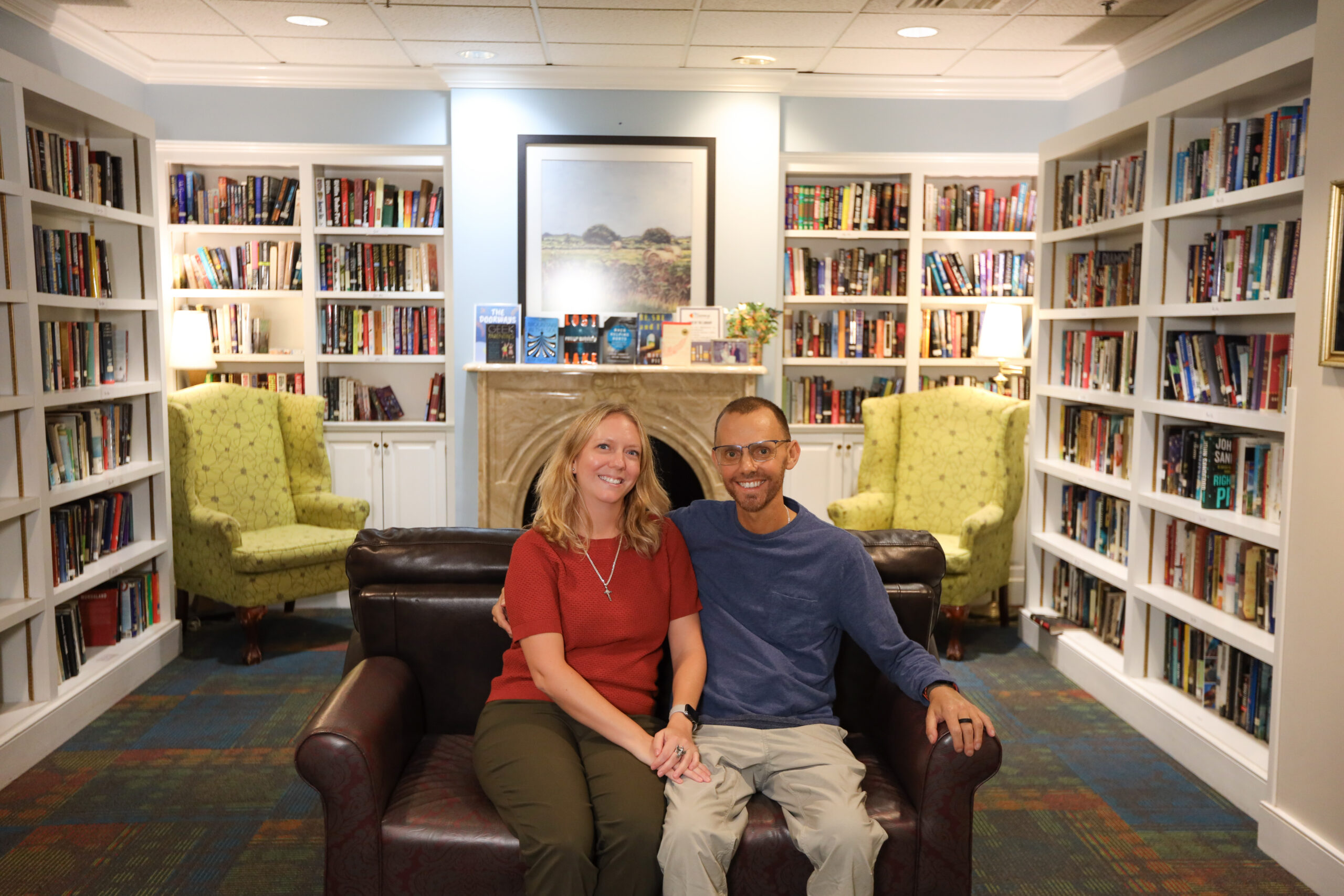 two smiling guests sit in the lobby of The Doorways