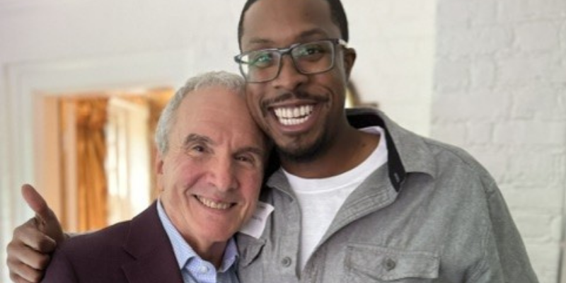 Two smiling adults hug