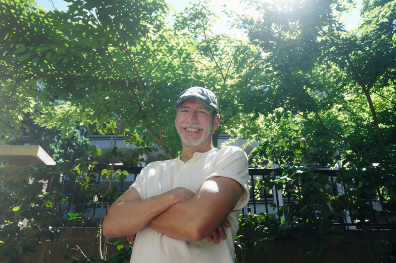 a smiling guest poses in Dolly's garden of The Doorways