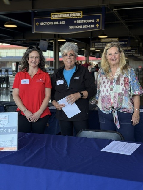 Smiling attendees at the 21st Annual Gilbane Restaurant Walk at CarMax Park