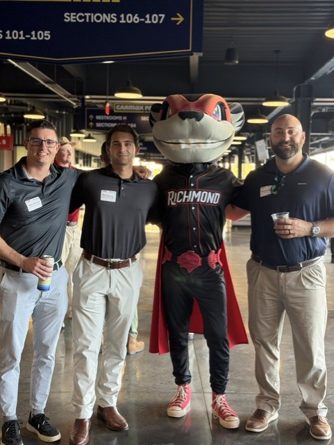 Smiling attendees at the 21st Annual Gilbane Restaurant Walk at CarMax Park with Nutzy
