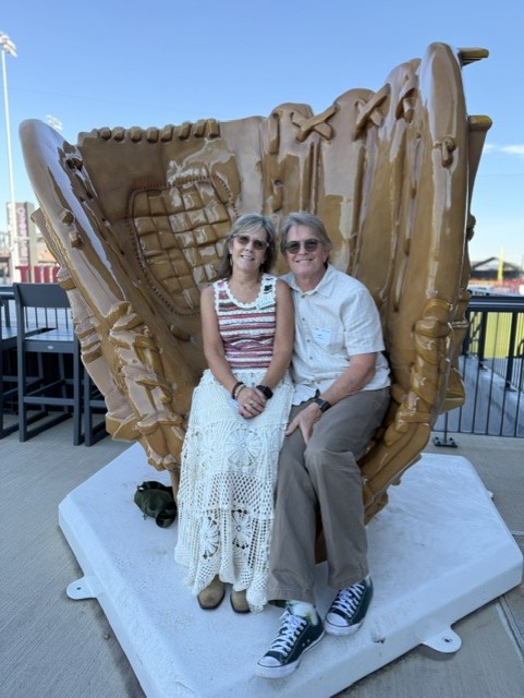 Smiling attendees at the 21st Annual Gilbane Restaurant Walk at CarMax Park pose with a giant baseball glove