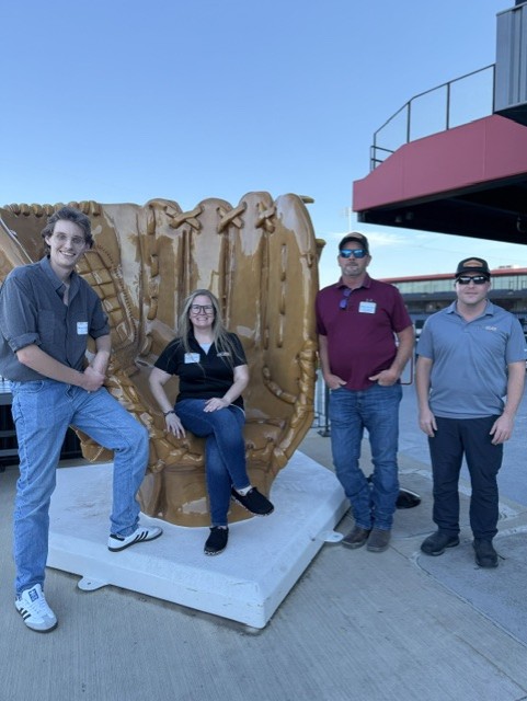 Smiling attendees at the 21st Annual Gilbane Restaurant Walk at CarMax Park pose with a giant baseball glove