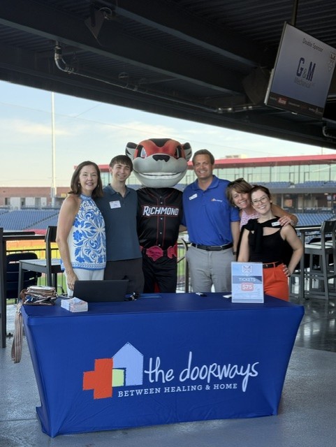 Smiling attendees at the 21st Annual Gilbane Restaurant Walk at CarMax Park with Nutzy