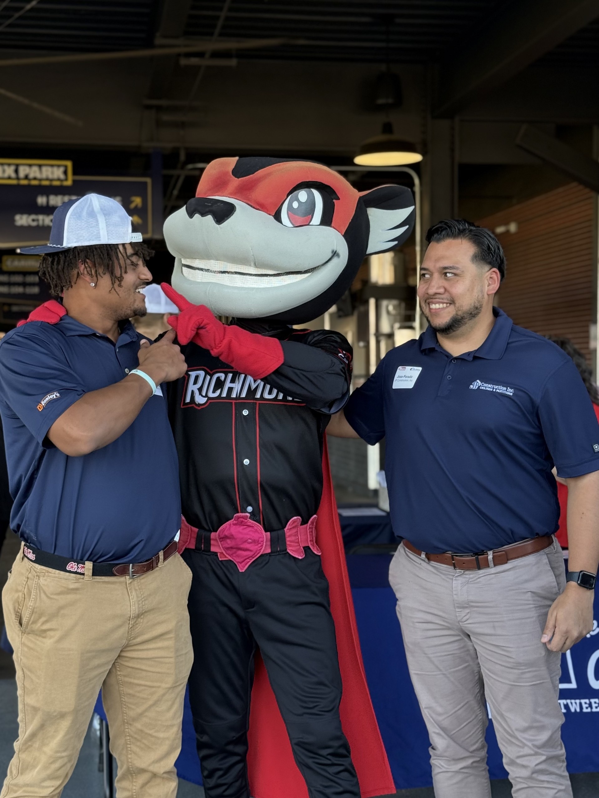 Smiling attendees at the 21st Annual Gilbane Restaurant Walk at CarMax Park pose with Nutzy