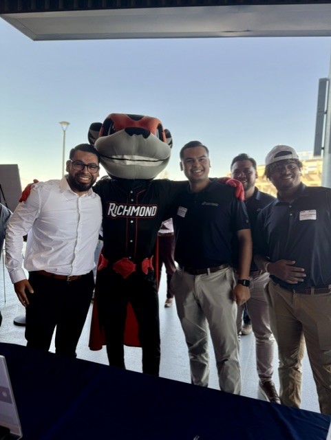 Smiling attendees at the 21st Annual Gilbane Restaurant Walk at CarMax Park pose with Nutzy