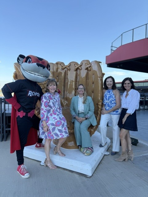 Smiling attendees at the 21st Annual Gilbane Restaurant Walk at CarMax Park pose with Nutzy and a giant baseball glove