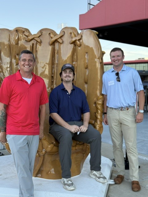 Smiling attendees at the 21st Annual Gilbane Restaurant Walk at CarMax Park pose with a giant baseball glove