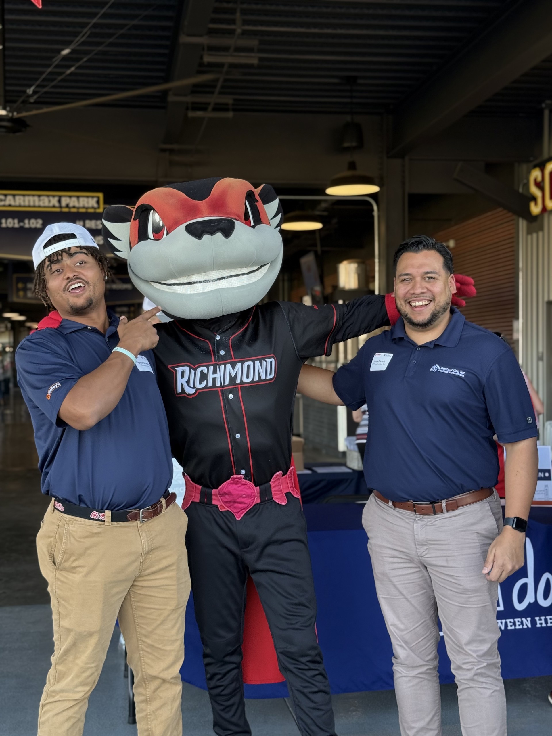 Smiling attendees at the 21st Annual Gilbane Restaurant Walk at CarMax Park pose with Nutzy