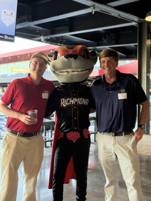 Smiling attendees at the 21st Annual Gilbane Restaurant Walk at CarMax Park with Nutzy